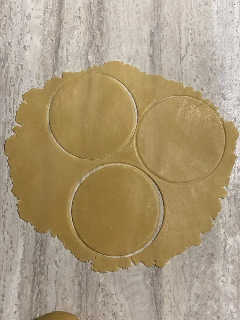 Rolled honey cake dough with three circle shapes cut out